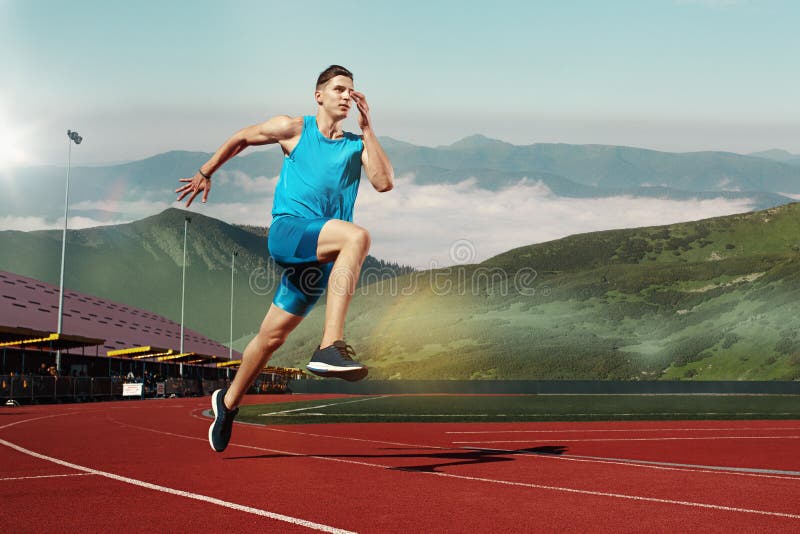 Man running in the track. Fit male fitness runner jogging in stadium