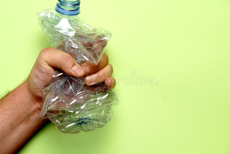 A Man Crushing a Plastic Water Bottle Stock Image Image of blue, background 165740865
