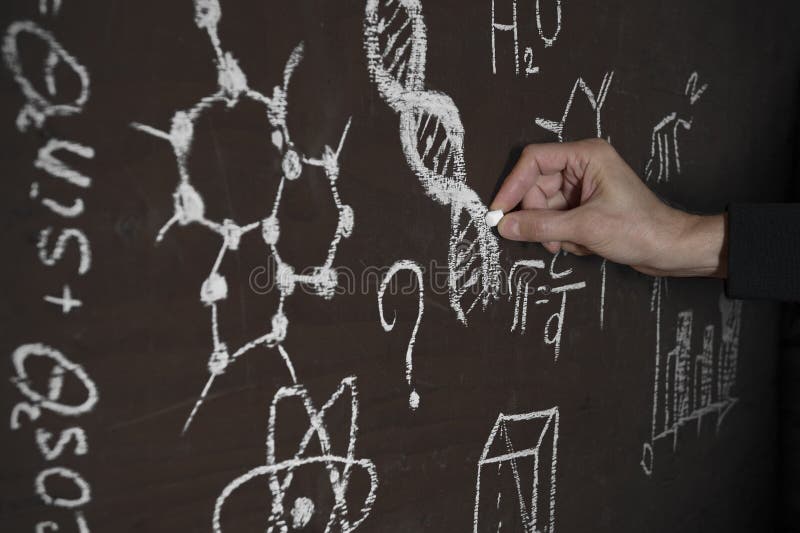 A man`s hand from darkness writes DNA code and formulas on an improvised chalkboard. stock photography A man`s hand from darkness writes DNA code and formulas on an improvised chalkboard. stock photography