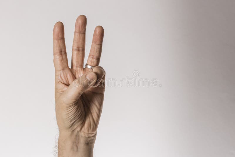 Man`s hand gesture, counting number three, isolated on white background - part of set stock photo Man`s hand gesture, counting number three, isolated on white background - part of set stock photo