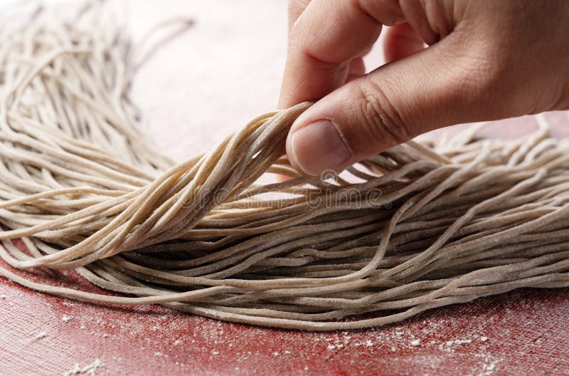 A Man`s Hand Holding Raw Soba Noodles Stock Image Image of flour