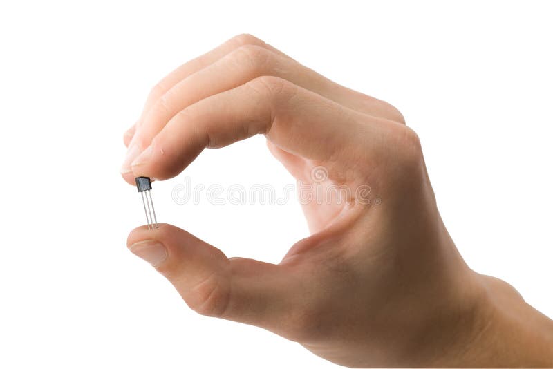 Man s hand holding a transistor isolated