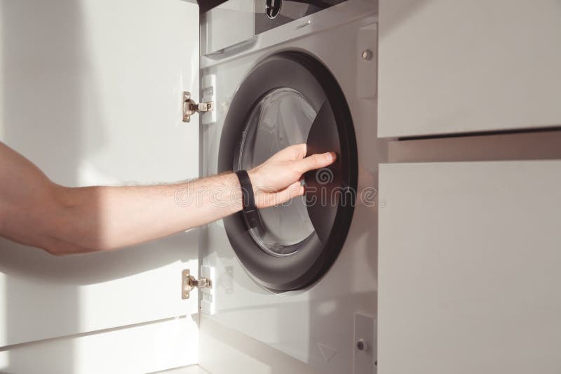 Man& X27;s Hand Opening Builtin Washing Machine in Kitchen Stock Image Image of technology