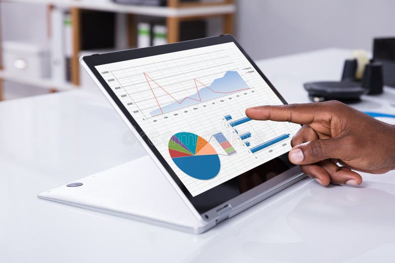 Man`s Hand Pointing On Graph At Laptop royalty free stock photo