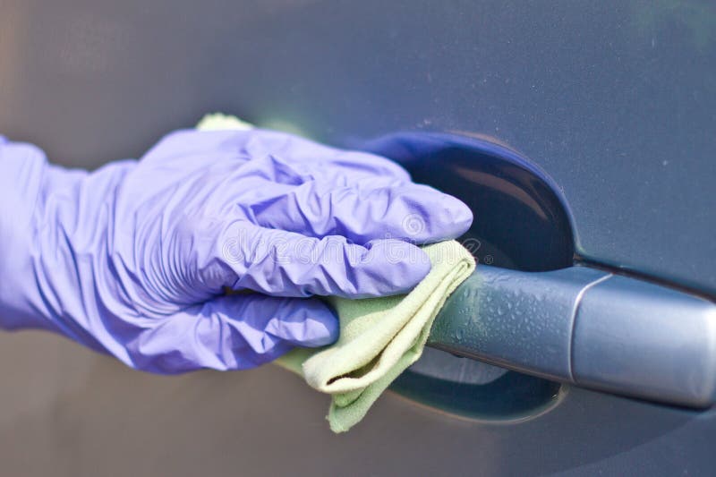 Man`s Hand in Protective Gloves Cleaning Car Door Handle Using