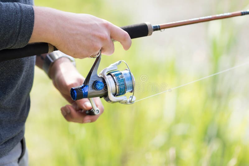 Man`s Hand Using Spinning Technique during Fishing Stock Image Image of lake, happy 149305121
