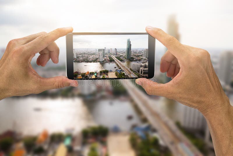 Man`s hands holding smartphone taking photo of Bangkok city,Thai royalty free stock images Man`s hands holding smartphone taking photo of Bangkok city,Thai royalty free stock images