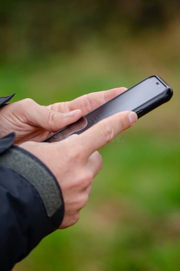 A man's hands using his smartphone royalty free stock image