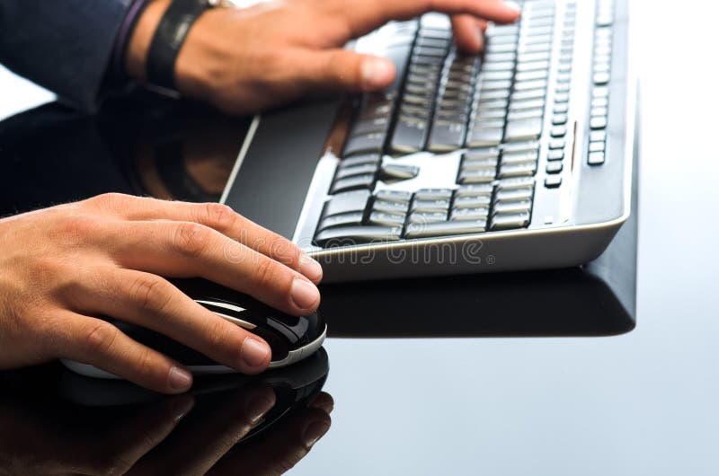 Man's hands working with computer mouse stock photography