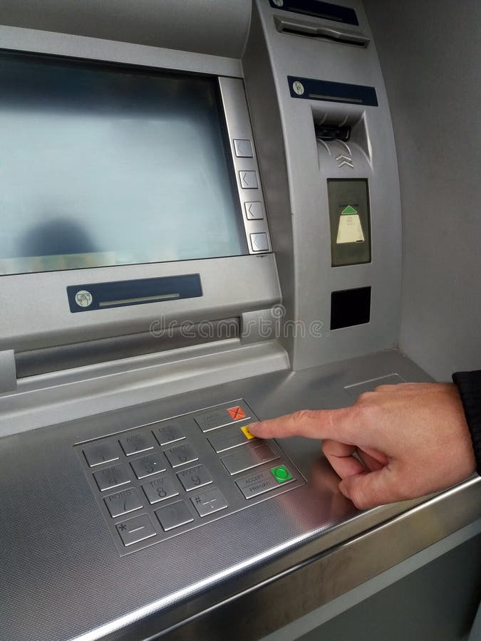 Man`s using the ATM machine with cash cards and entering PIN/pass code on keypad. stock photo Man`s using the ATM machine with cash cards and entering PIN/pass code on keypad. stock photo