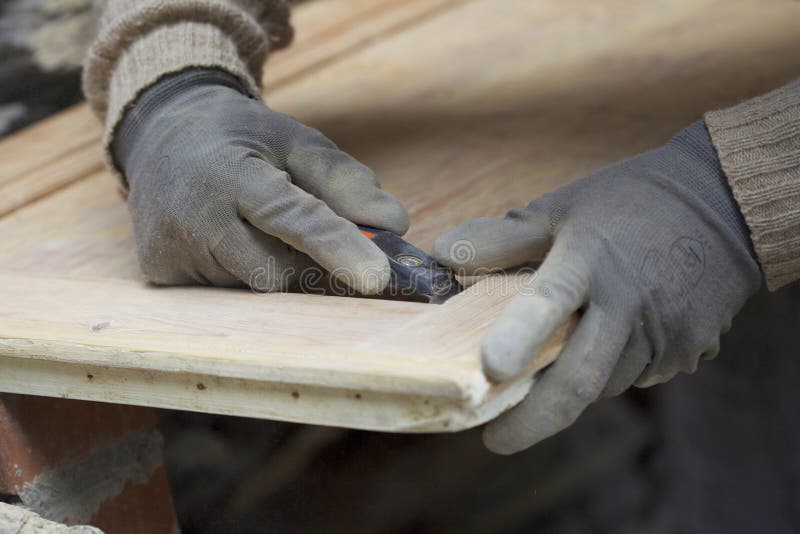 Man sanding a piece of wood. Man sanding a piece of wood.