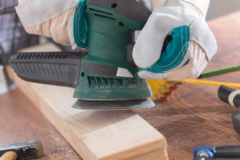 Man Sanding a Wood with Orbital Sander Stock Photo Image of male