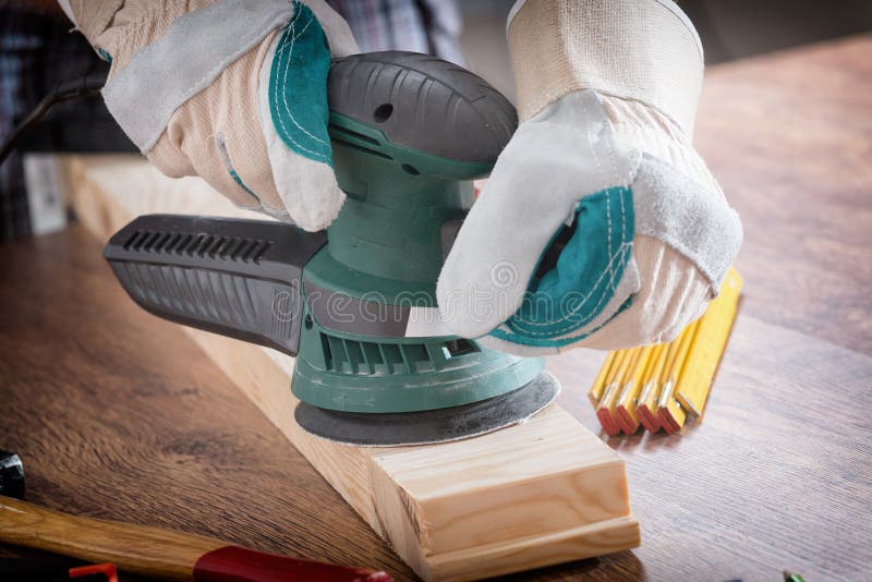 Man Sanding a Wood with Orbital Sander Stock Photo Image of