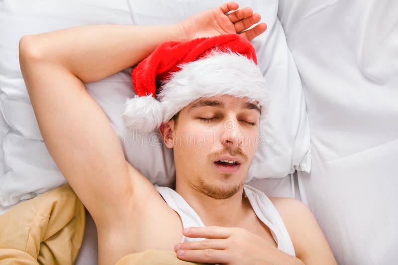 Man in Santa Hat sleeping stock photo. Image of cute 161582362