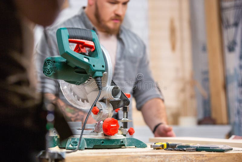 Man Sawing Wood With A Circular Saw On A Workbench Stock Photo - Image of flooring, joiner
