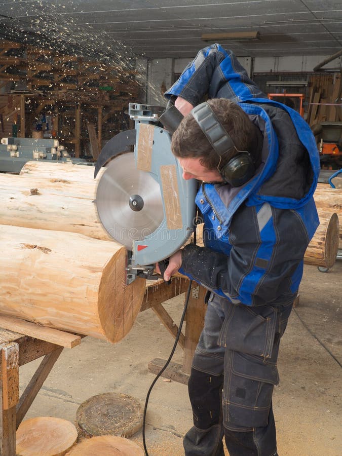 Man Saws Wood Logs with a Chainsaw Stock Photo Image of indoors
