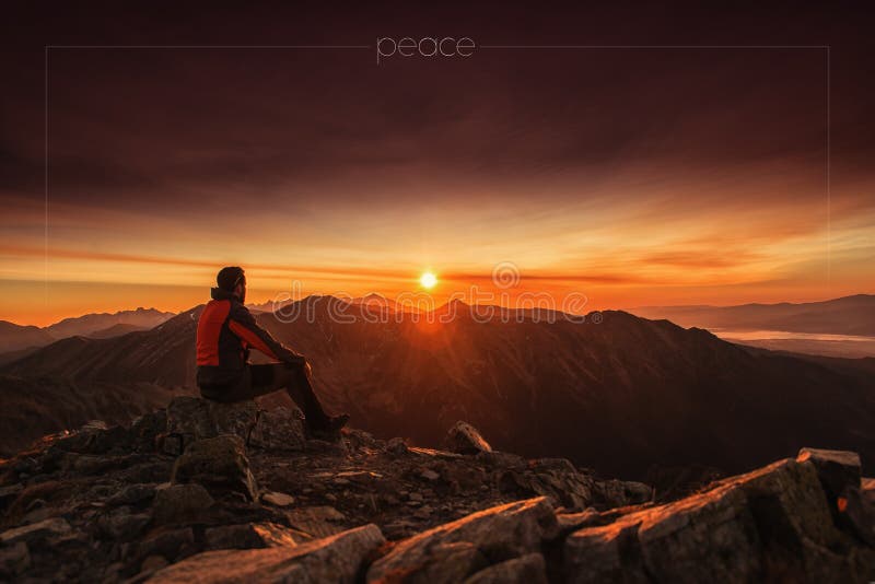 Man seating on the top of mountain at sunrise, hiking and climbing