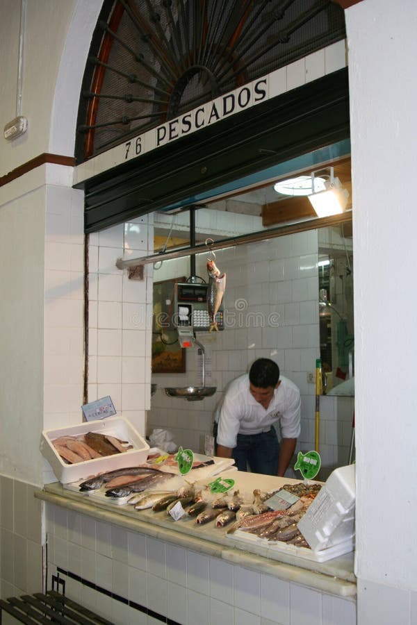 Worker is selling seafood at the market, Andalusia, Sevilla,Spain