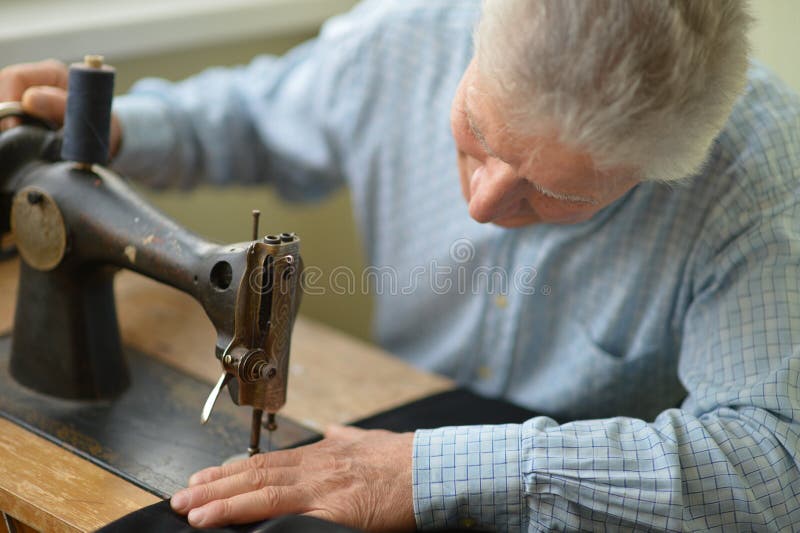 Man with sewing machine royalty free stock images
