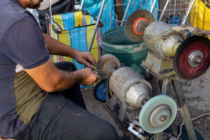 Man Sharpening a Knife in the Market Stock Image Image of grinder