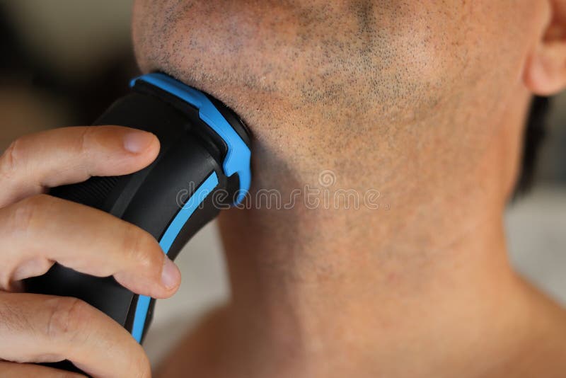 A man shaves his beard. stock image. Image of bathroom 249163909