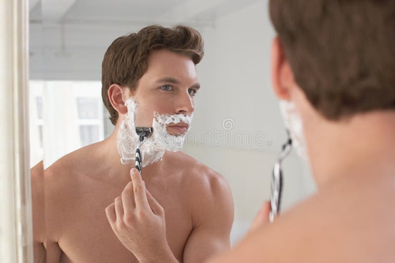 Man Shaving In Bathroom Mirror