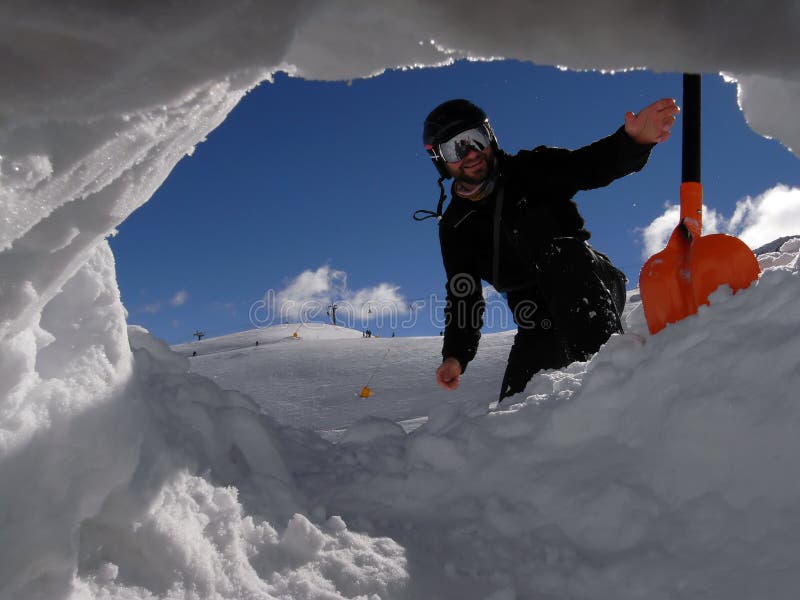 Man with shovel from the snow hole