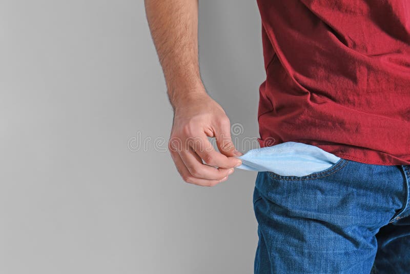Man Showing Empty Pocket On Light Background, Closeup Stock Photo Image of beggar, jeans