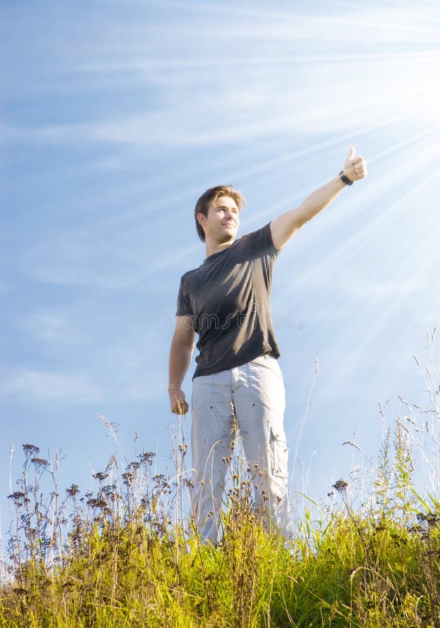 Joyful man showing excellent sign. Bright sun with rays.