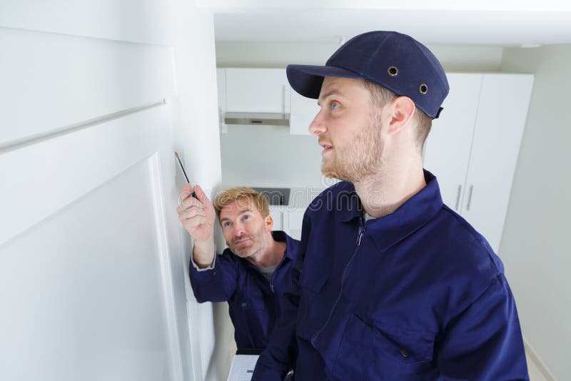 Man Showing Painter Man Where To Paint on Wall Stock Image Image of