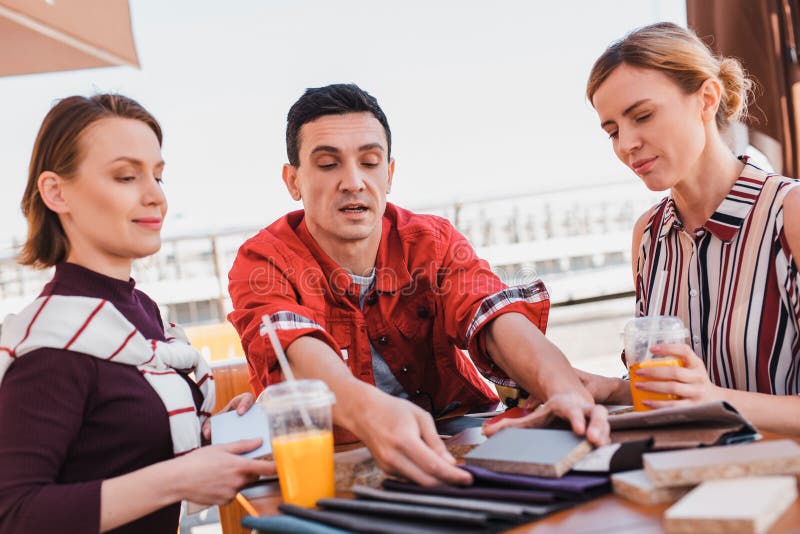 Man showing samples of materials to customers during the lunch stock image Man showing samples of materials to customers during the lunch stock image