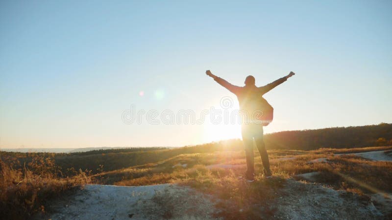 Man silhouette striving for success hand to hand walking tourist hiking adventure climbers sunset climb the mountain