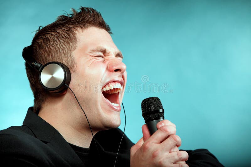 Man singing into microphone happy karaoke signer royalty free stock photography Man singing into microphone happy karaoke signer royalty free stock photography