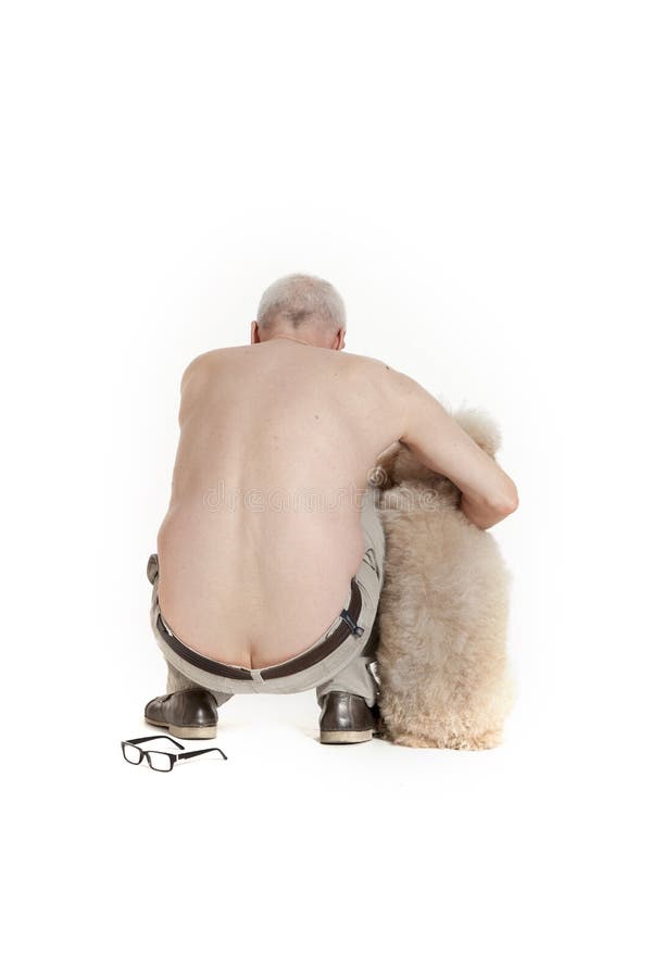 Man sits with his back to the camera with a dog