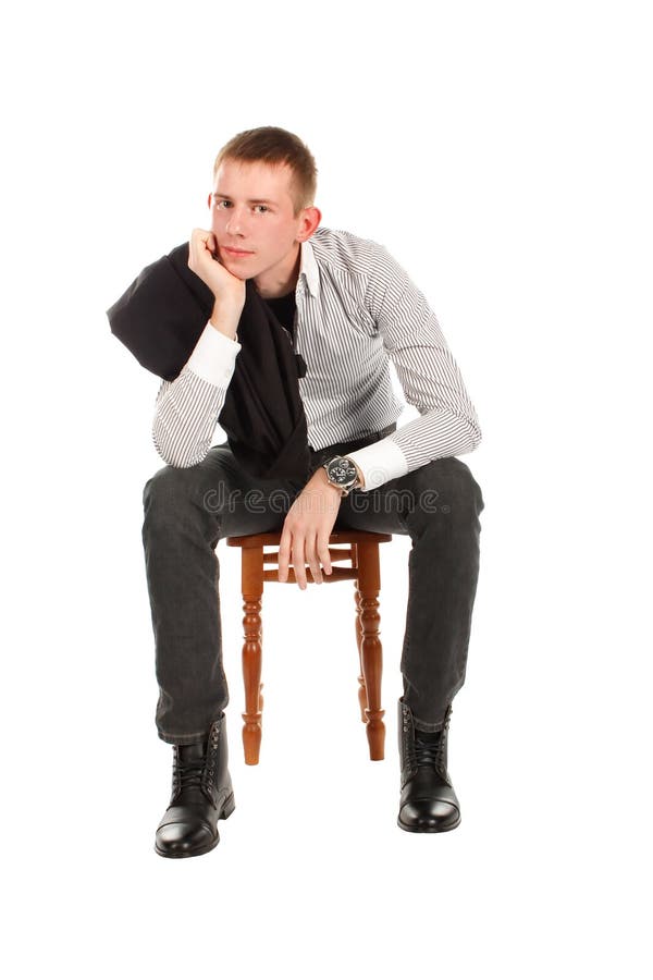 Man sitting on a chair against a white background