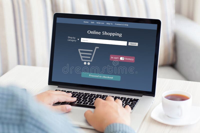 Man sitting at a computer and makes online shopping royalty free stock image