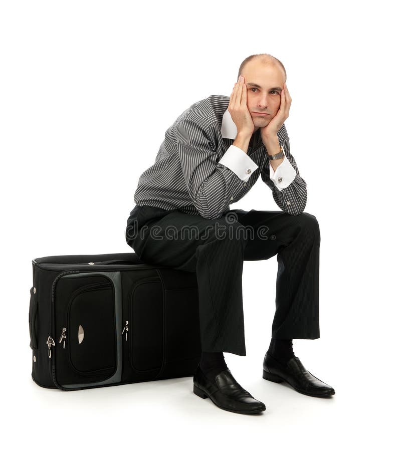 Man sitting on his luggage