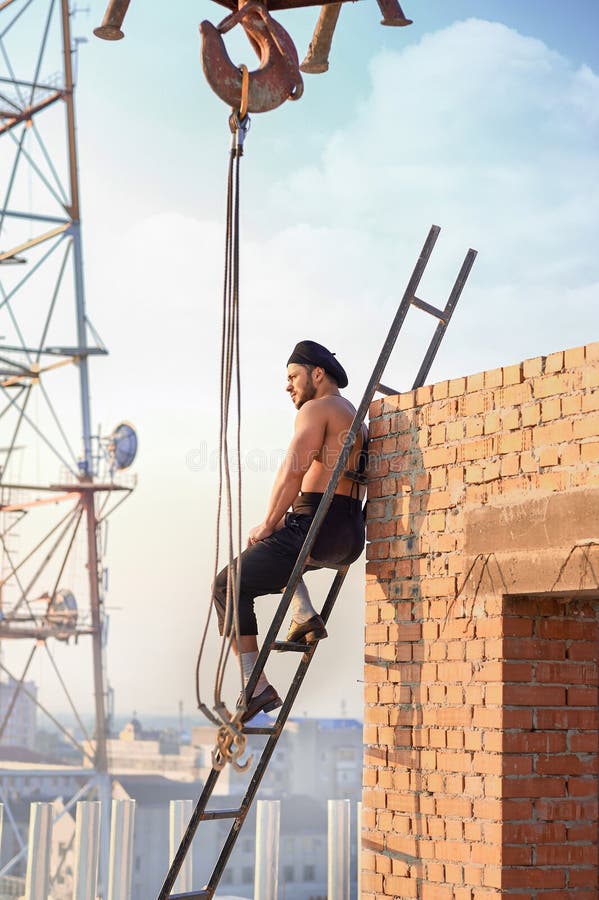 Man sitting on ladder on high.