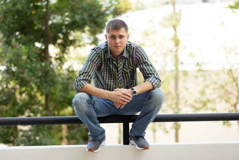 Man sitting on a ledge stock photo. Image of style, modern - 51426174