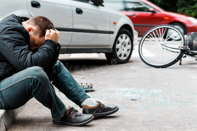 Man sitting on sidewalk