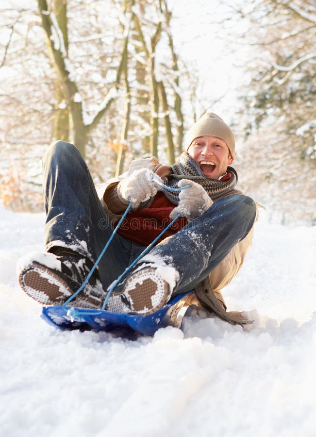 Man Sledging Through Snowy Woodland royalty free stock image Man Sledging Through Snowy Woodland royalty free stock image