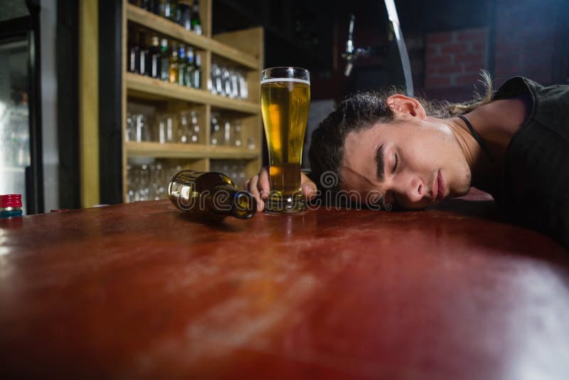 Man Sleeping on Bar Counter Stock Photo - Image of leaning, class: 93235034