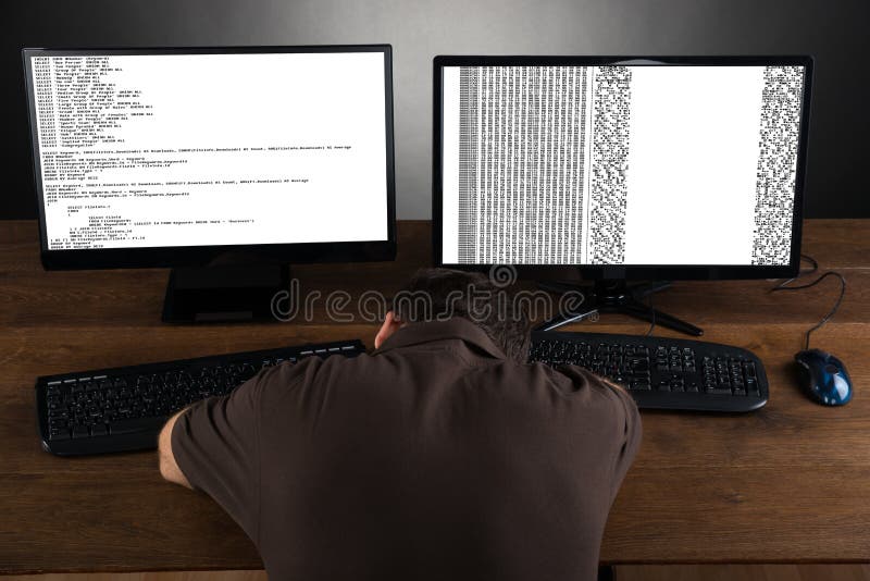 Man Sleeping At Desk With Computers Showing Program Code. Source code script stock images, royalty-free photos and pictures