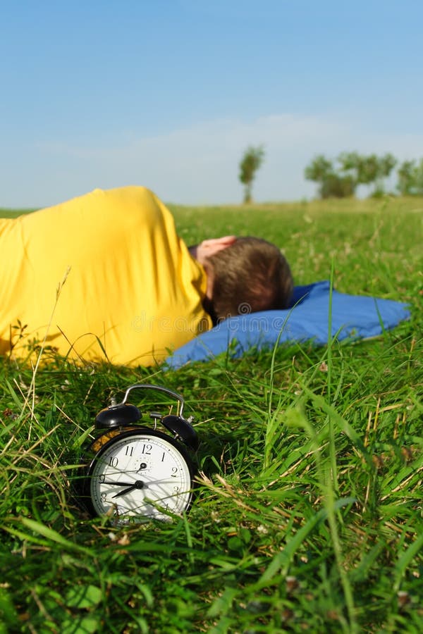 Man sleeping on summer lawn