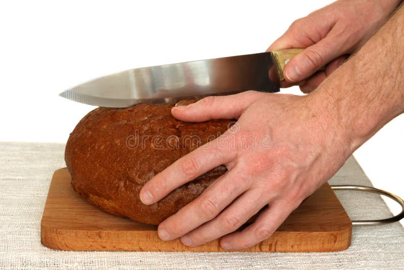 Man slicing bread on a wooden board