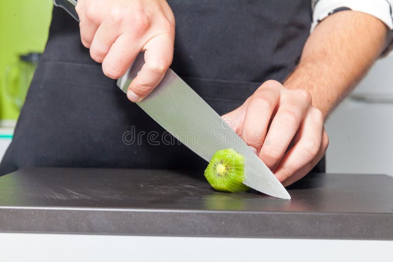 Man slicing kiwi fruit stock image. Image of chef, nature 78482425