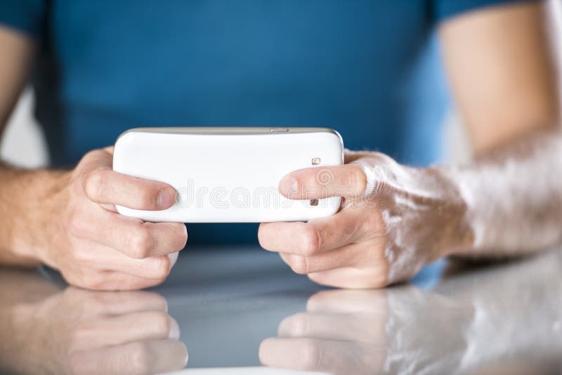 Man with smartphone. Close up of a man using mobile smart phone