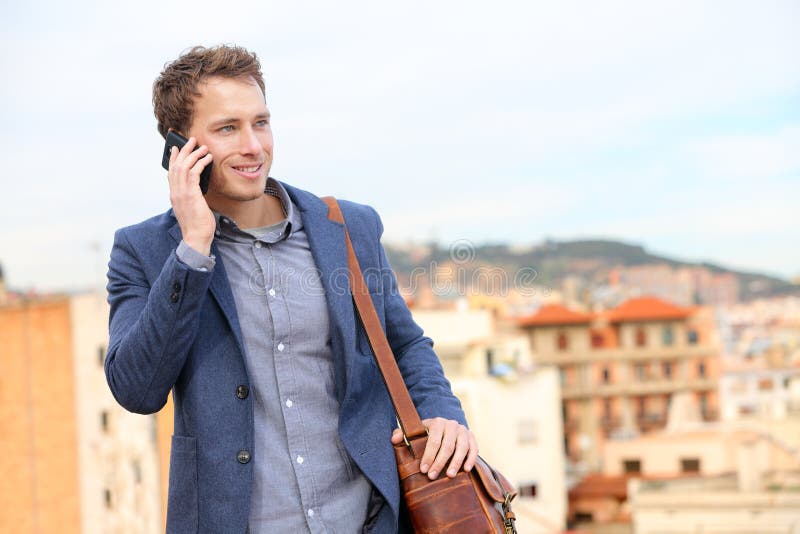 Man on smartphone - young business man talking on smart phone. Casual urban professional businessman using mobile cell phone smiling happy walking. Handsome man wearing suit jacket in Barcelona, Spain