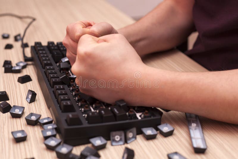 Man smashes a mechanical computer keyboard in rage using both fists royalty free stock photos Man smashes a mechanical computer keyboard in rage using both fists royalty free stock photos