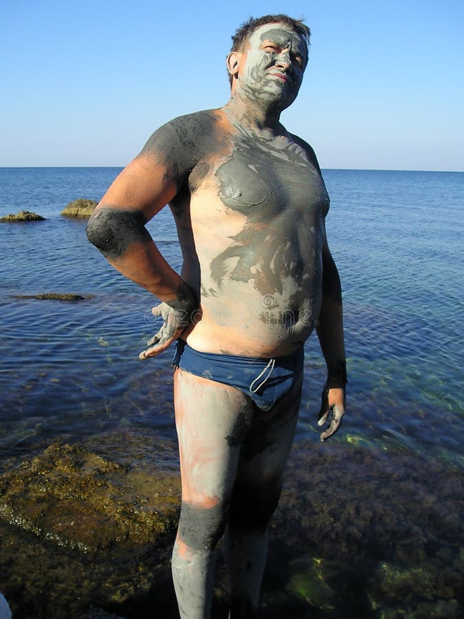 Man, smeared by mud at sea